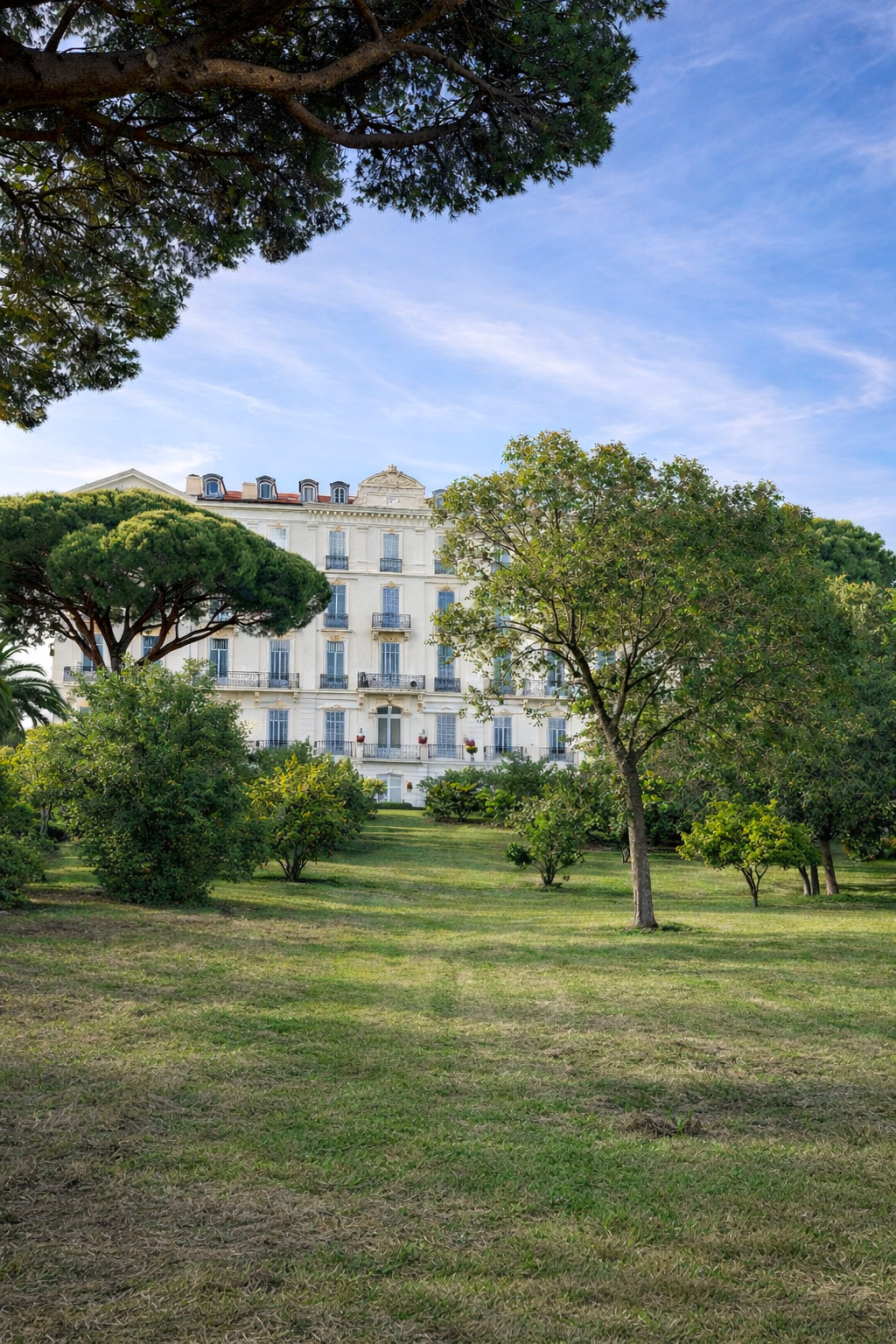Résidence des Pins Belle Époque facade seen through the trees of its private park