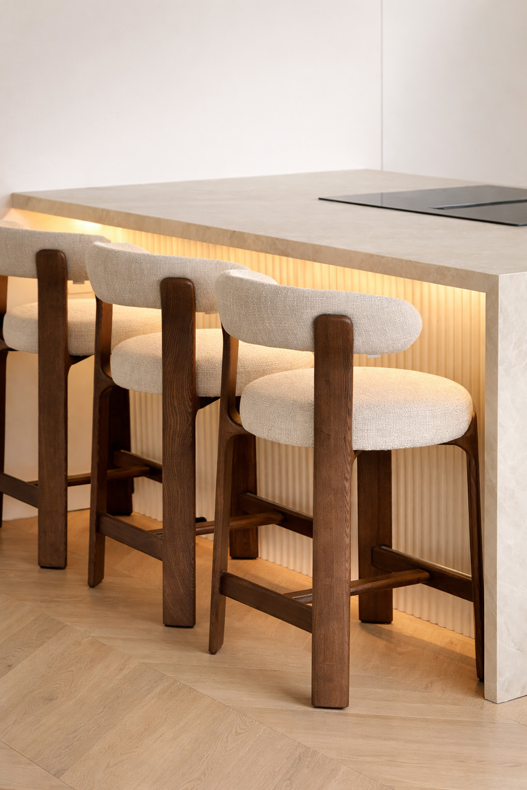 Detail of upholstered bar stools at the kitchen counter