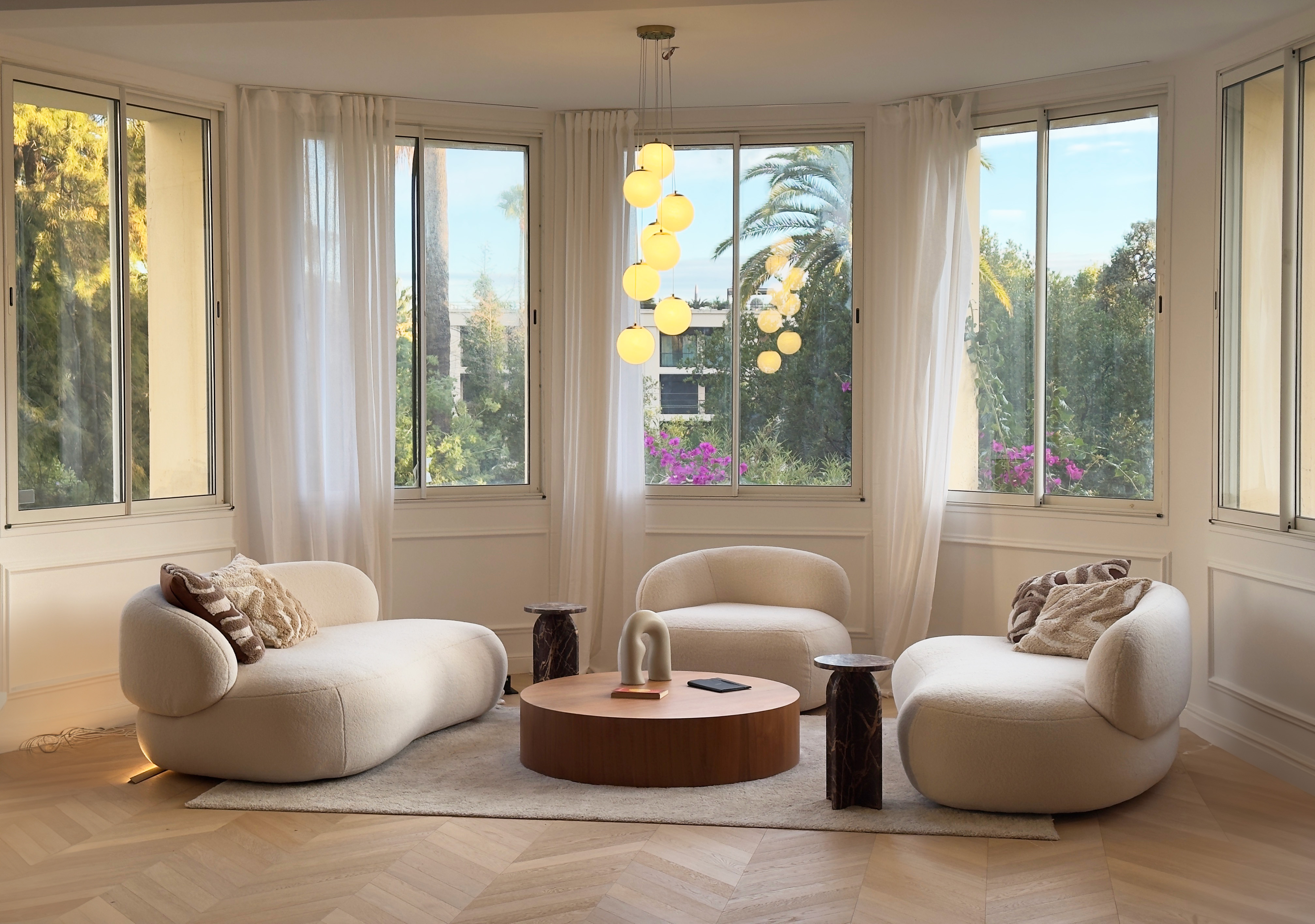 Wide view of living room through the curved bow window, afternoon light