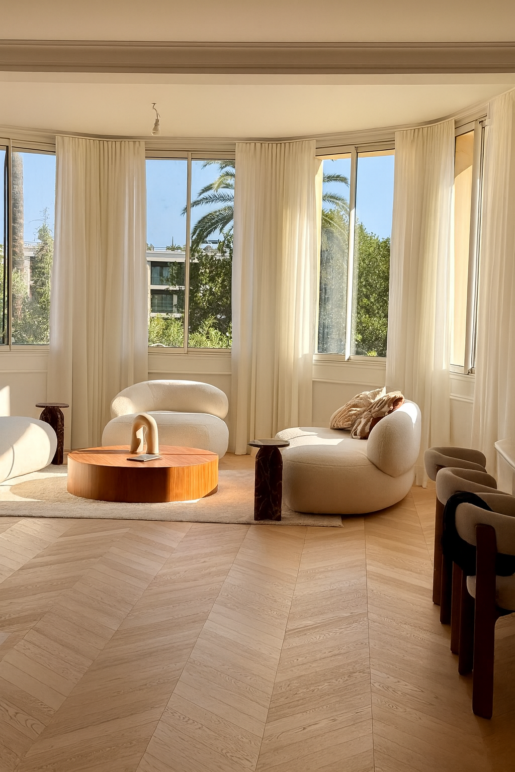 Dining area with sculptural table and view onto private garden
