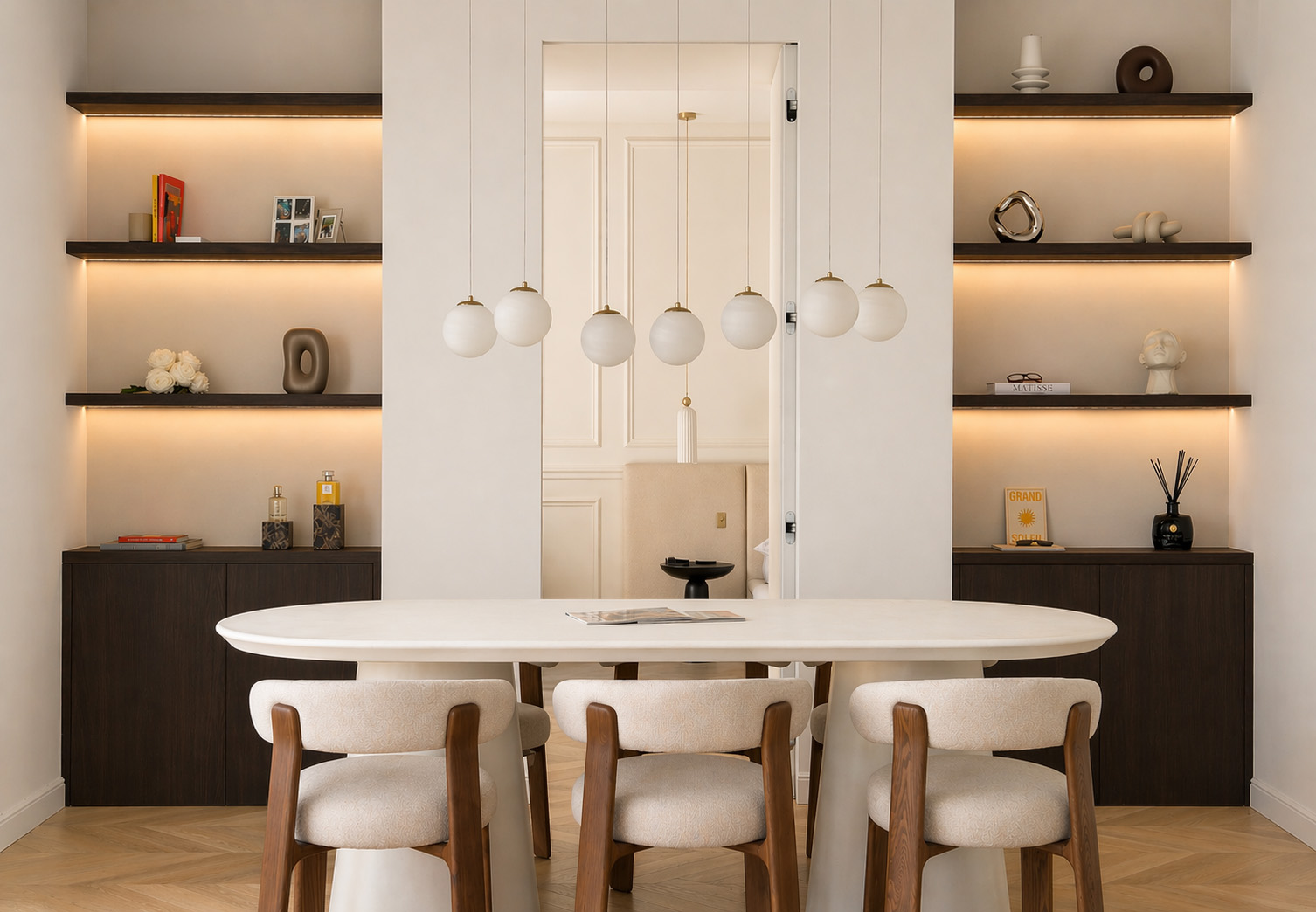 Living room with bouclé sofas, globe pendant lights, and herringbone oak floor